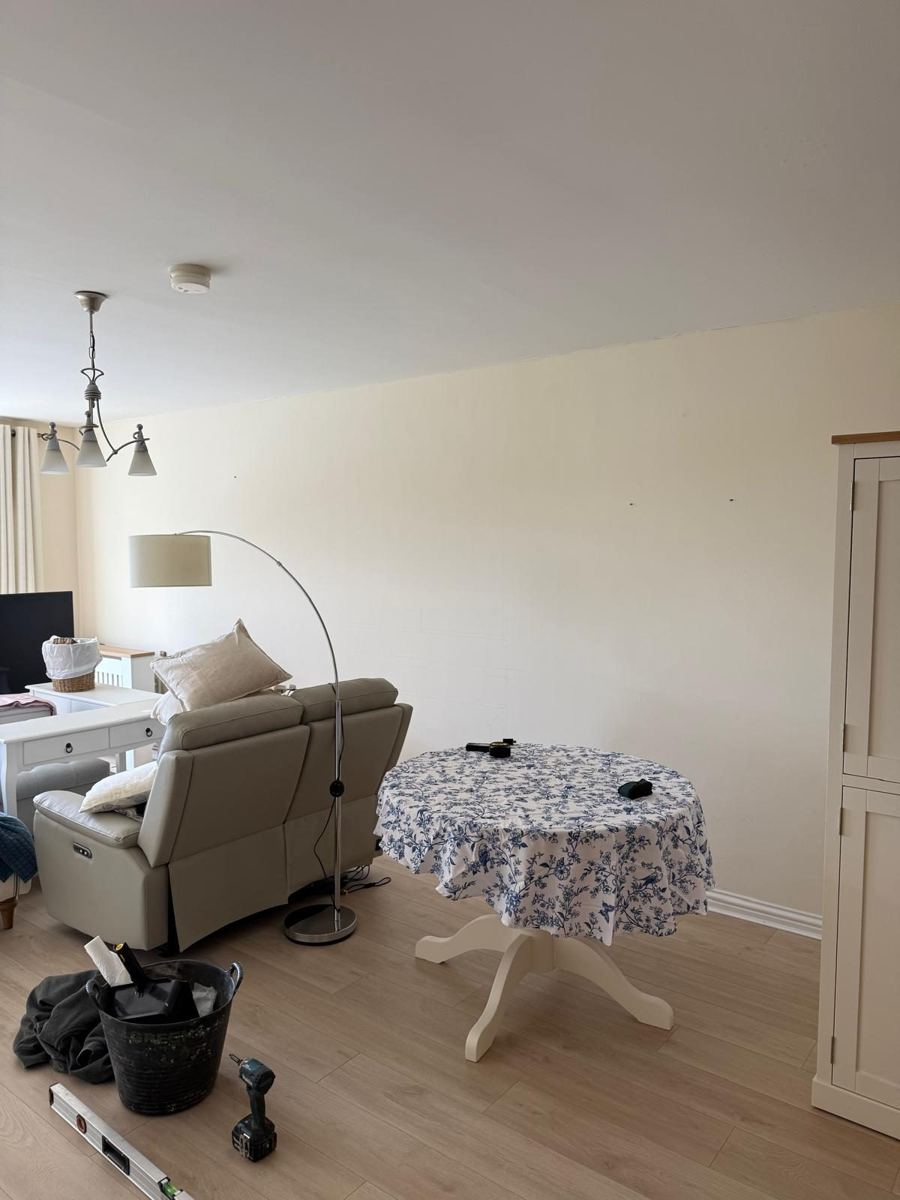 Plain cream living room wall before panelling