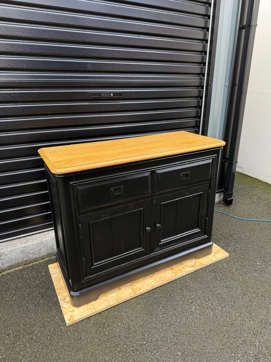 The same sideboard painted black with black handles and a refreshed oak top